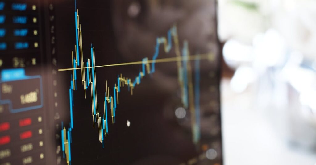 Detailed view of financial trading graphs on a monitor, illustrating stock market trends.